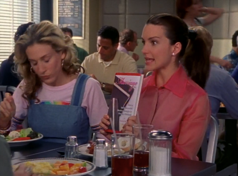 Charlotte with a self-help book and an EXTREMELY shiny blouse in season 3.